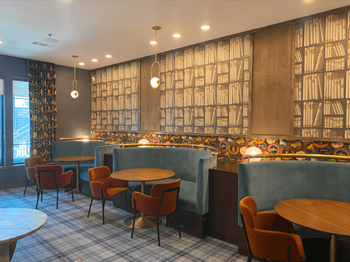 a restaurant with blue booths and chairs and tables